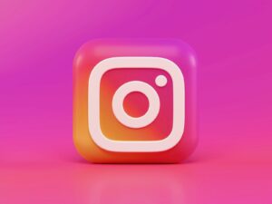 A three-dimensional Instagram logo icon with a pink and orange gradient background